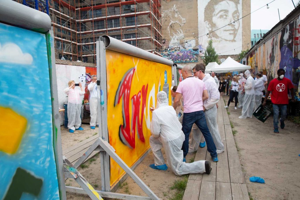 Team of delegates collaboate to make lifesize grafiti art in Berlin at a The Wentworth Collective global partner conference